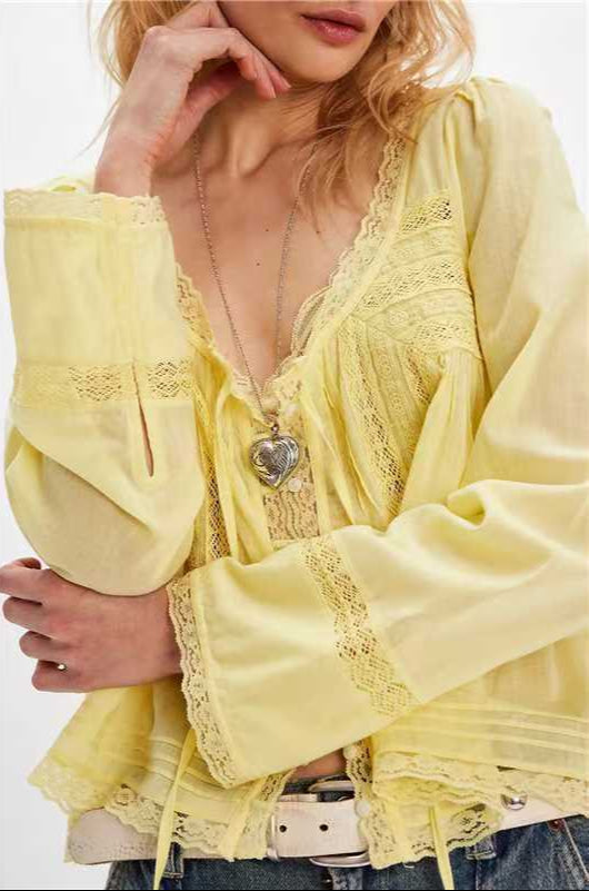 Yellow lace top worn by a person on a white background