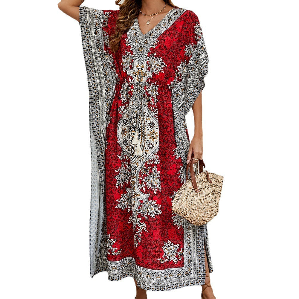 Red and gray patterned dress worn by a person on a white background