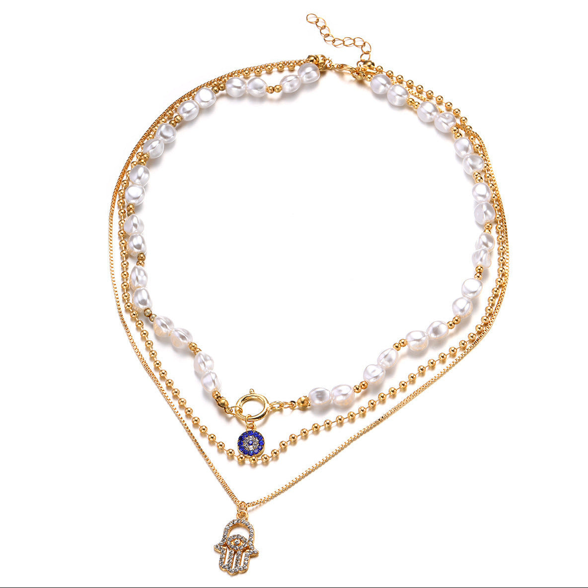 Layered necklace with gold chain, pearl beads, and blue evil eye charm on a white background