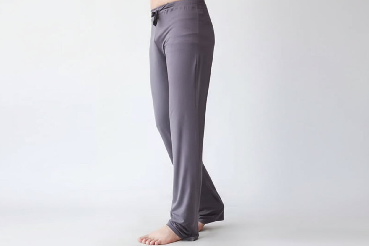 Gray pants worn by a person on a white background