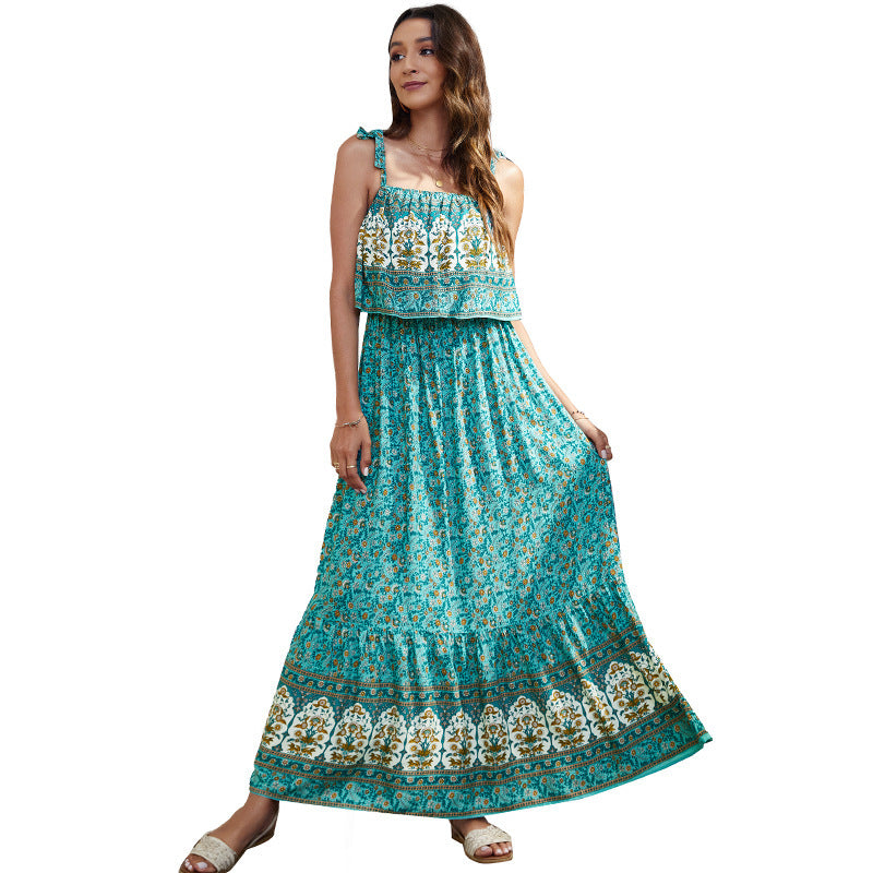 Woman wearing a turquoise floral dress on a white background