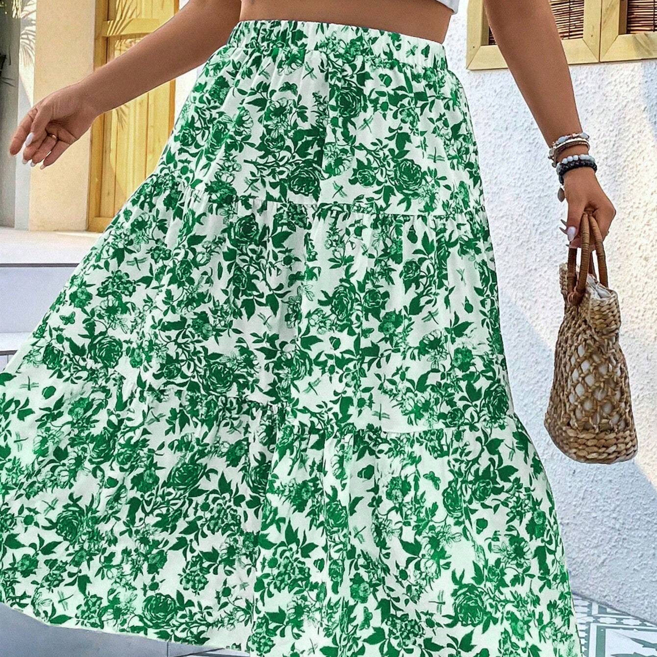 Person wearing a green floral skirt with a textured bag in the background