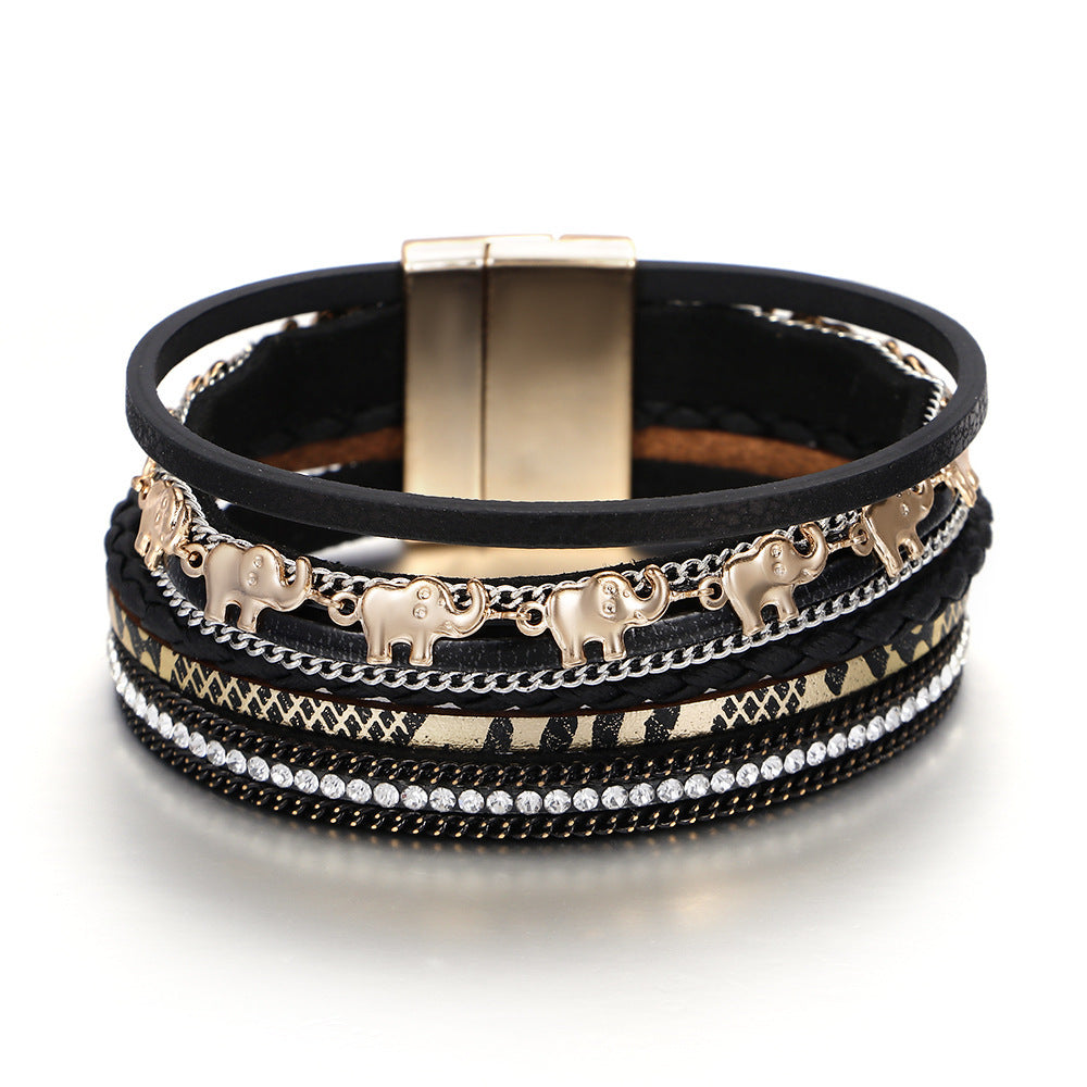 Black leather bracelet with gold elephant charms and a magnetic clasp on a white background