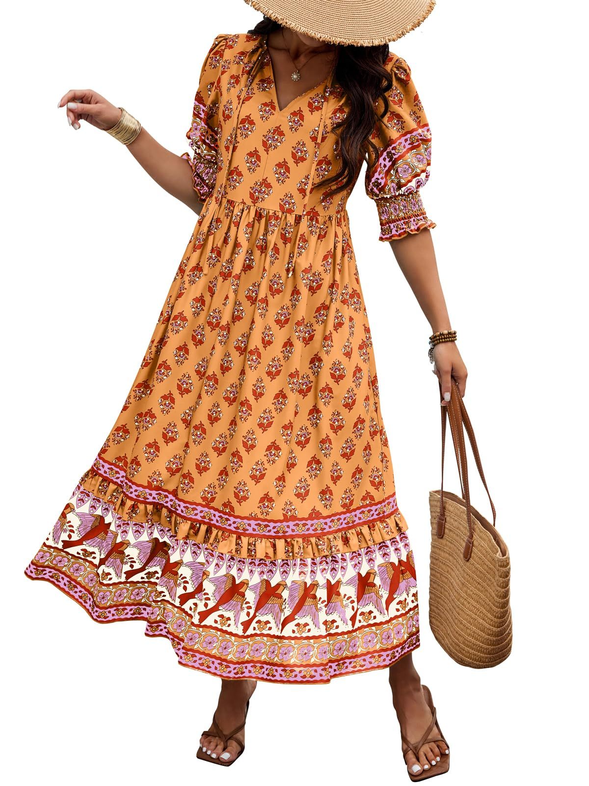 Woman wearing a patterned orange dress with a straw hat and bag on a white background