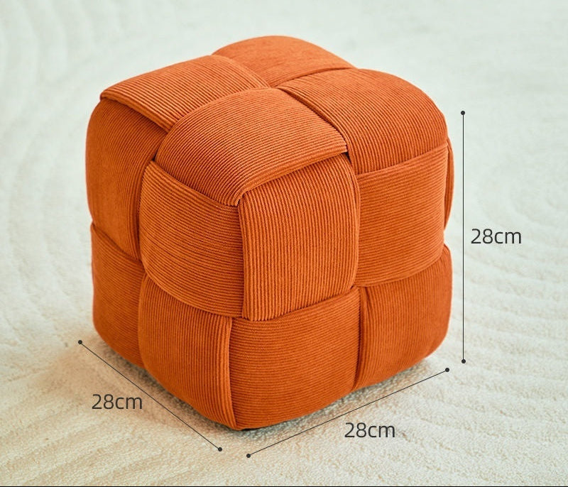 Orange cube-shaped ottoman with dimensions on a light background