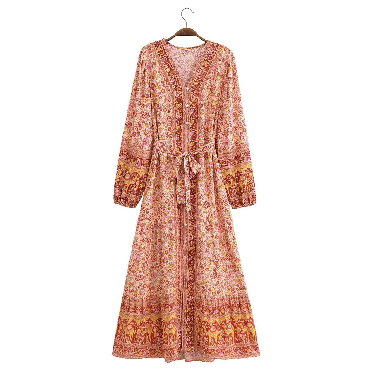 Long floral dress on a hanger against a white background