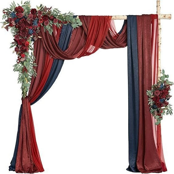 Decorative arch with red and blue drapes and floral arrangements on a white background