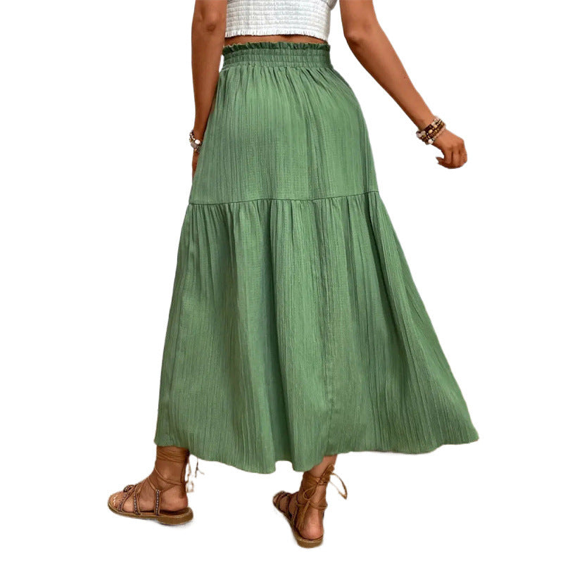 Green tiered skirt worn by a person on a white background