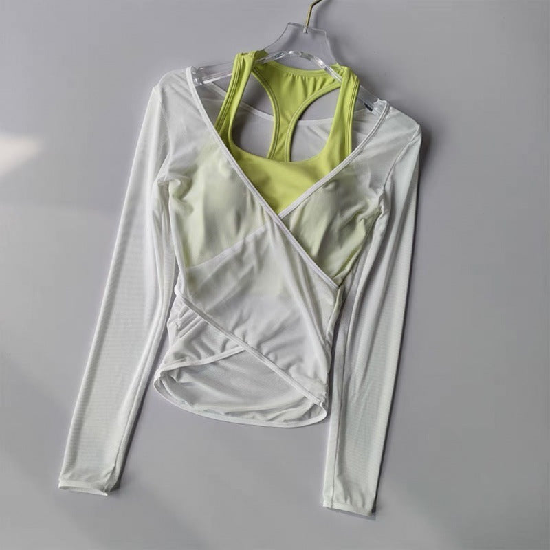 Light gray long-sleeve athletic top with green sports bra on a gray background
