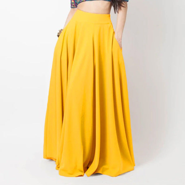 Yellow long skirt worn by a person on a plain background