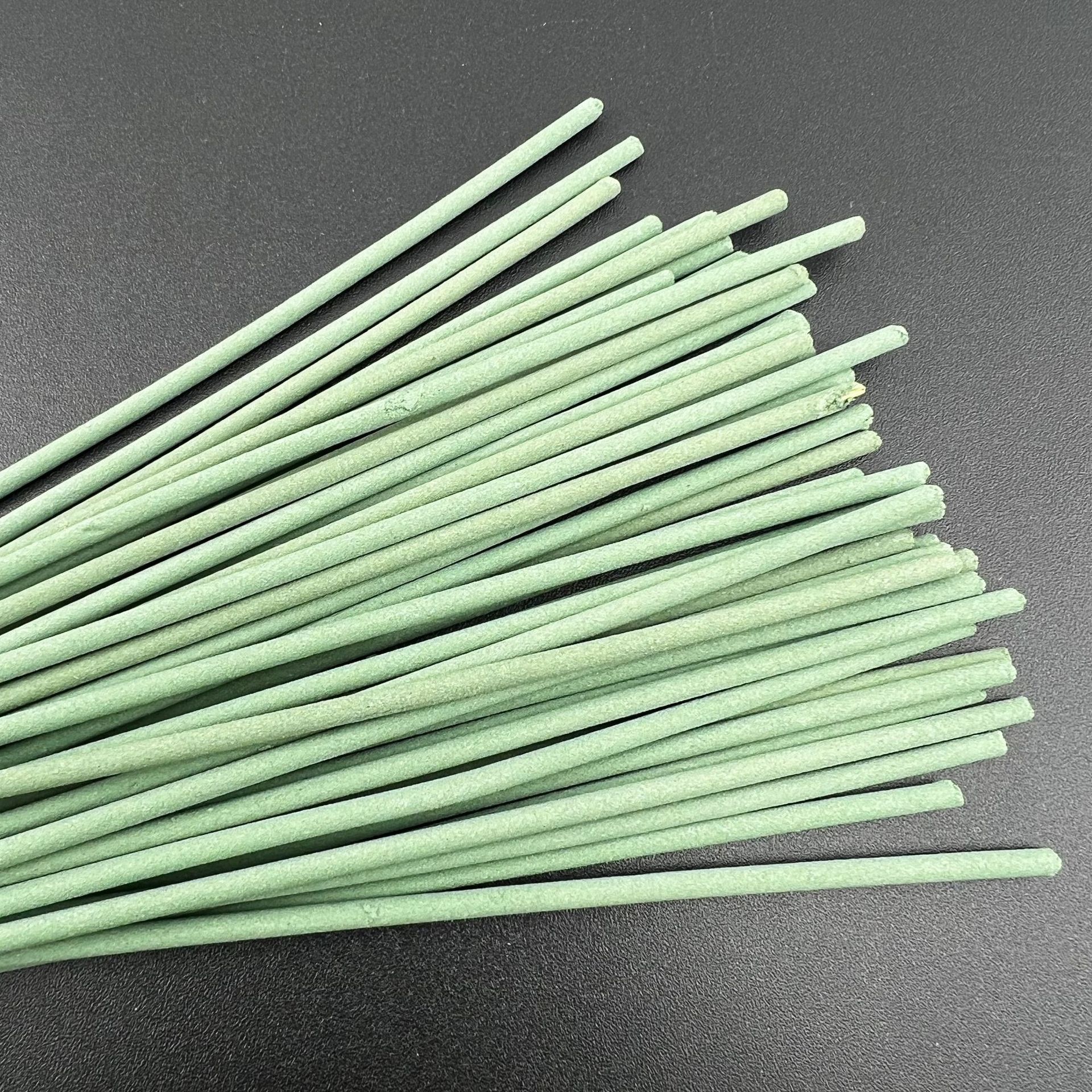 Green sticks on a black background