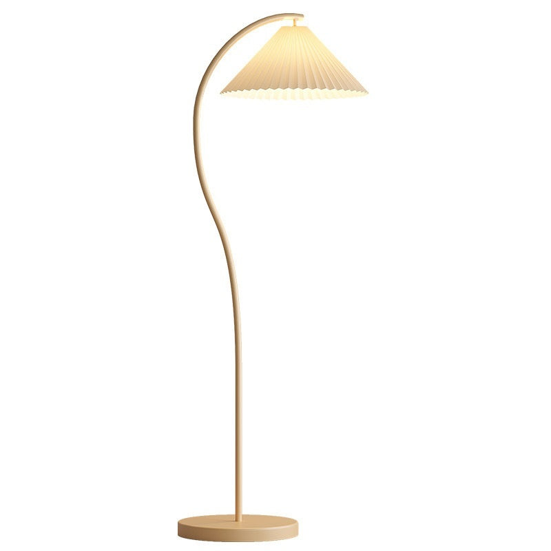 Floor lamp with a curved design and pleated shade on a white background