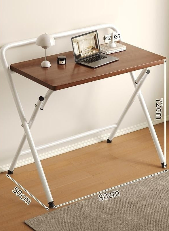Folding desk with wooden top and white metal frame on a plain background