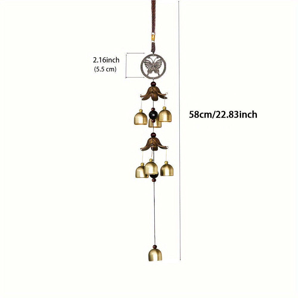 Decorative hanging bell with butterfly design and measurements on a white background