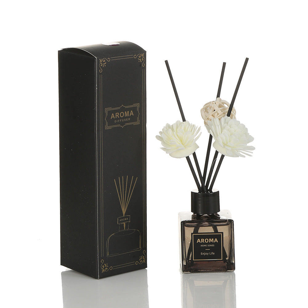 Aroma diffuser with floral reeds and packaging on a white background