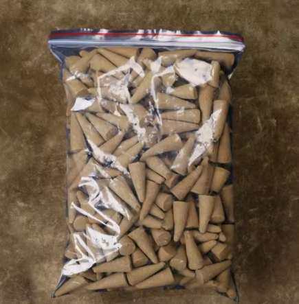 Bag of wooden cones on a brown surface