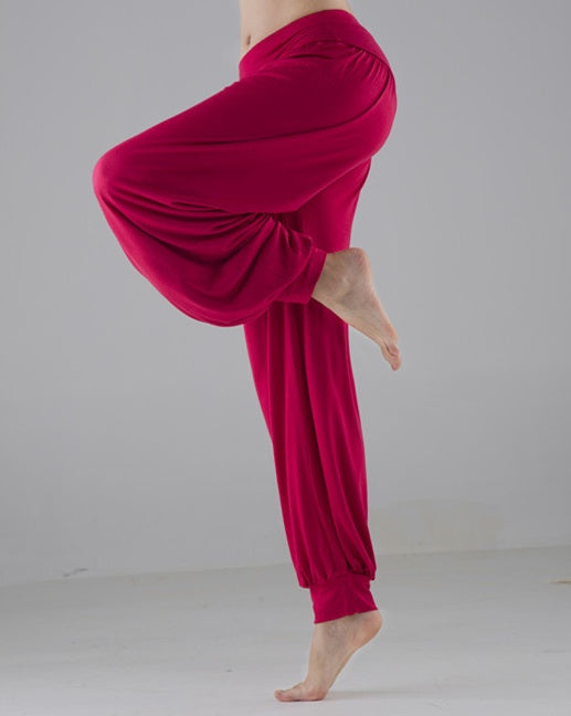 Person wearing bright pink pants on a plain background