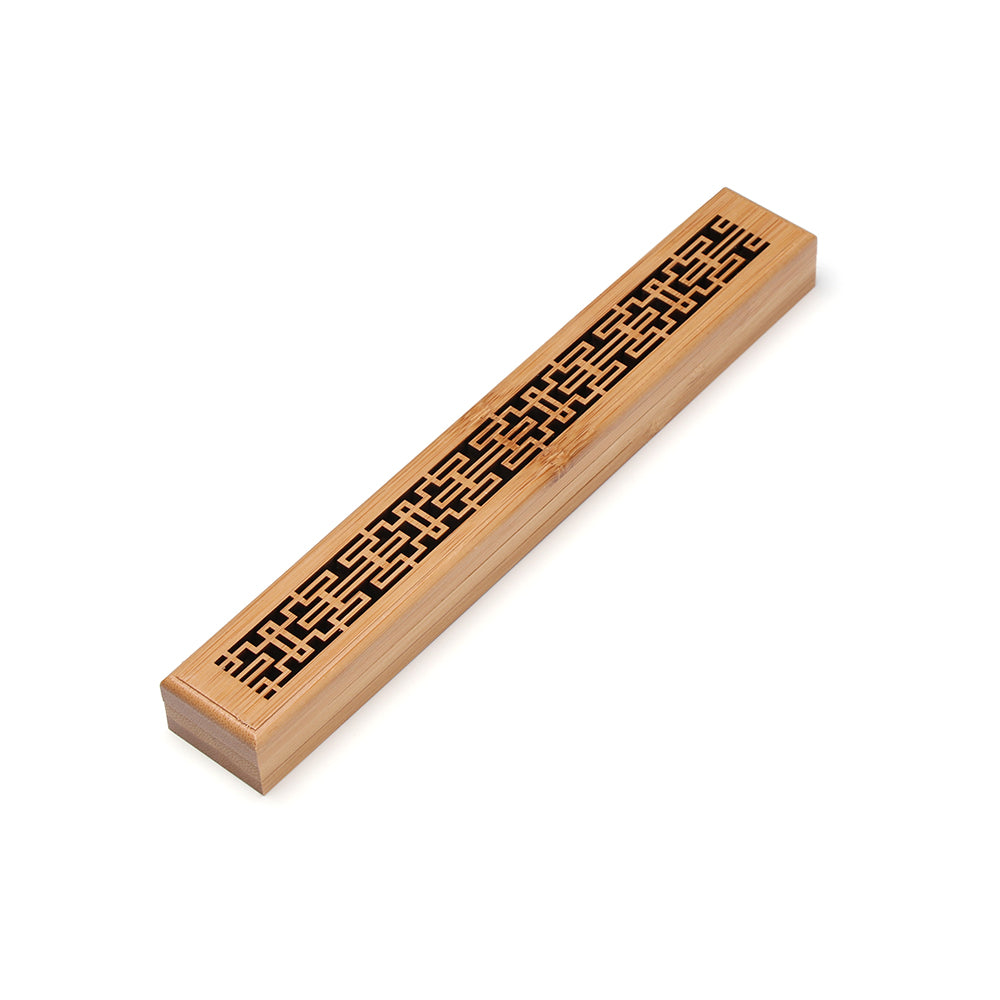 Bamboo incense holder with intricate patterns on a white background