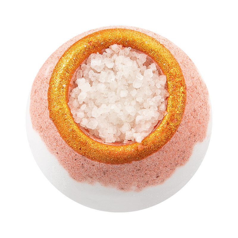 Bath bomb with pink and gold exterior on a white background