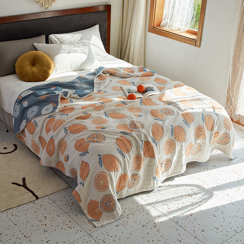 Bed with a floral-patterned comforter in a bright bedroom