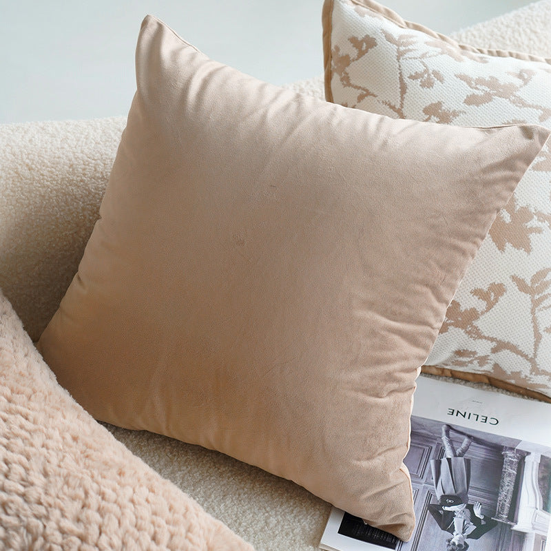 Beige pillow on a textured surface with a magazine underneath