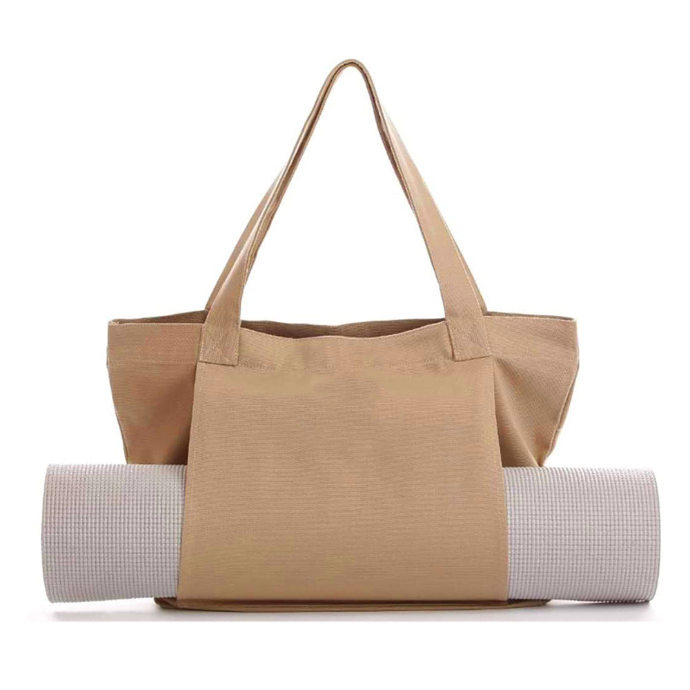 Beige tote bag with a yoga mat on a white background