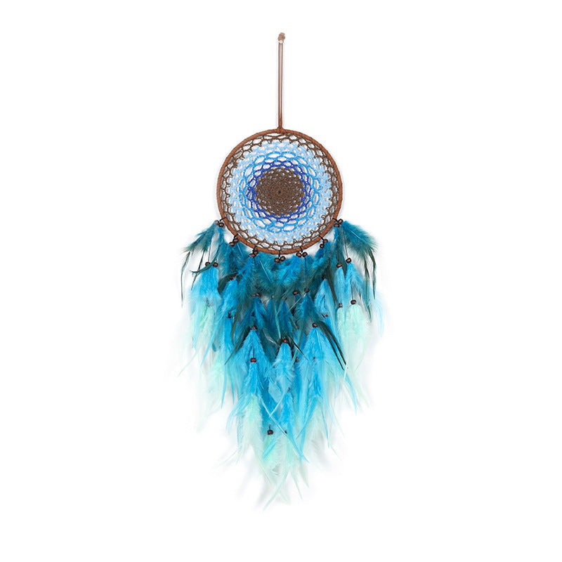 Dreamcatcher with blue feathers on a white background
