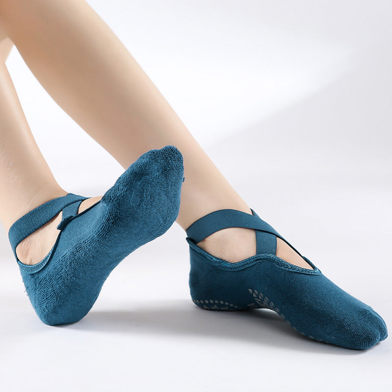 Blue ballet shoes worn by a person on a white background