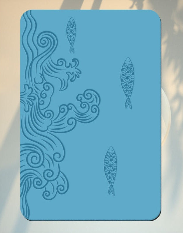 Blue placemat with wave and fish design on a blurred natural background