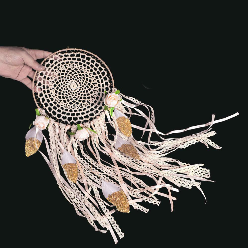 Handmade dreamcatcher with decorative elements on a black background