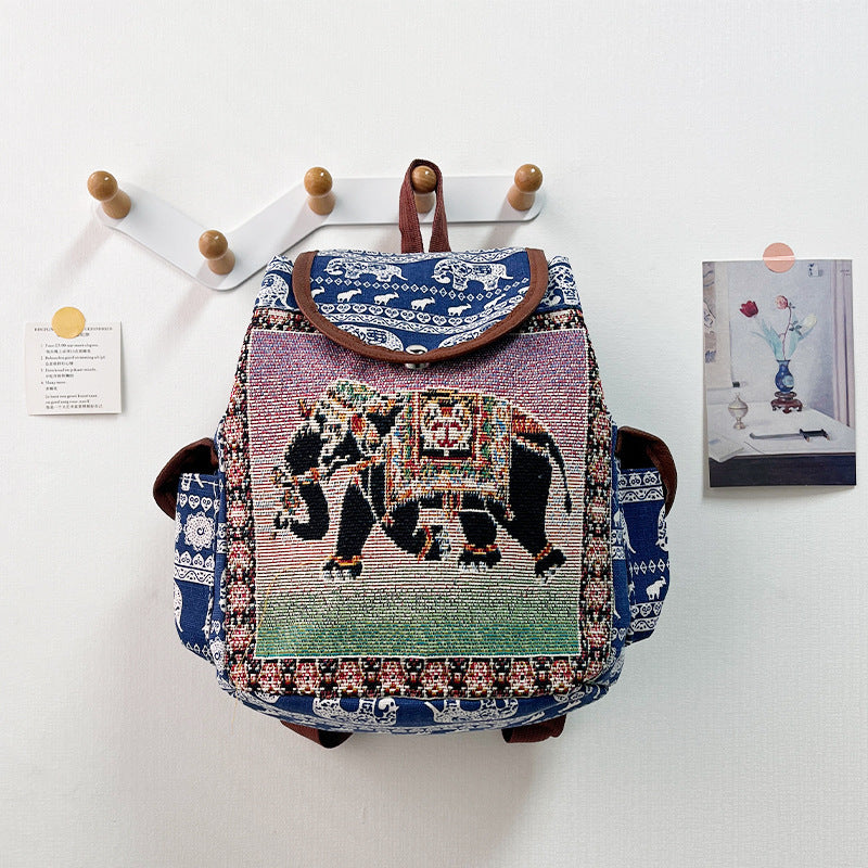 Colorful backpack with elephant design on a white wall