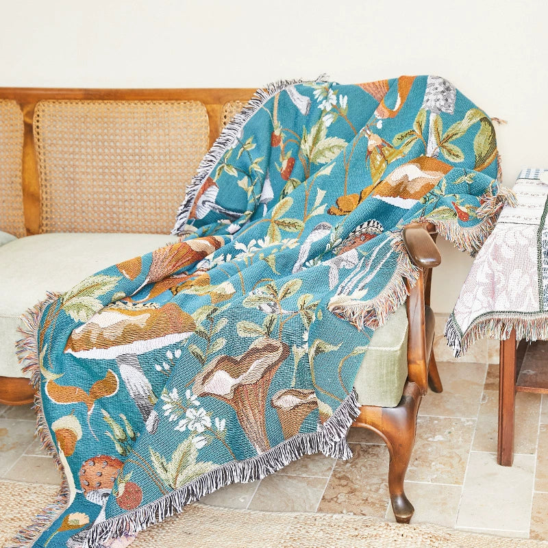 Decorative blanket with fox pattern draped over a chair in a room setting.
