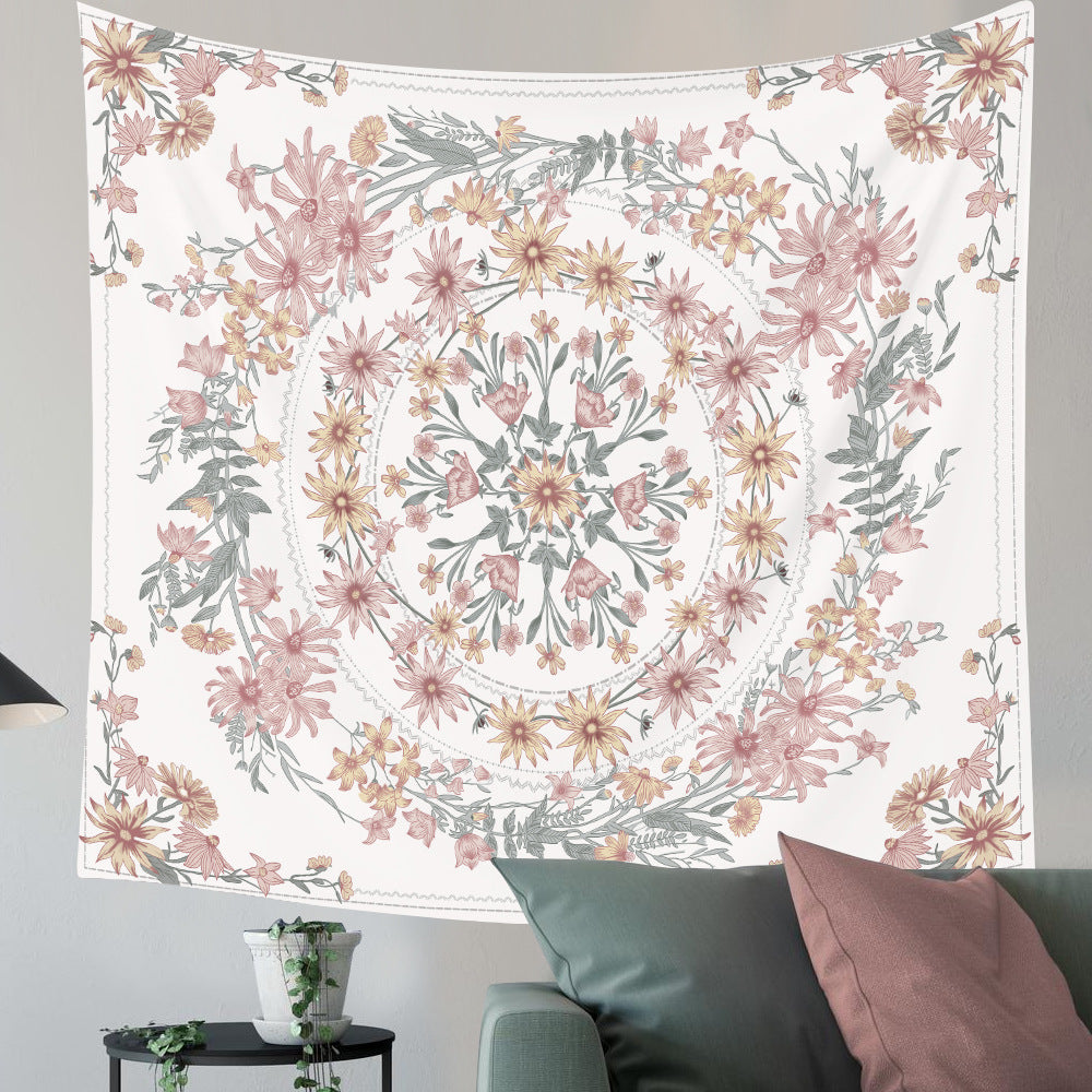 Floral tapestry with pink and green flowers hanging on a wall above a sofa.