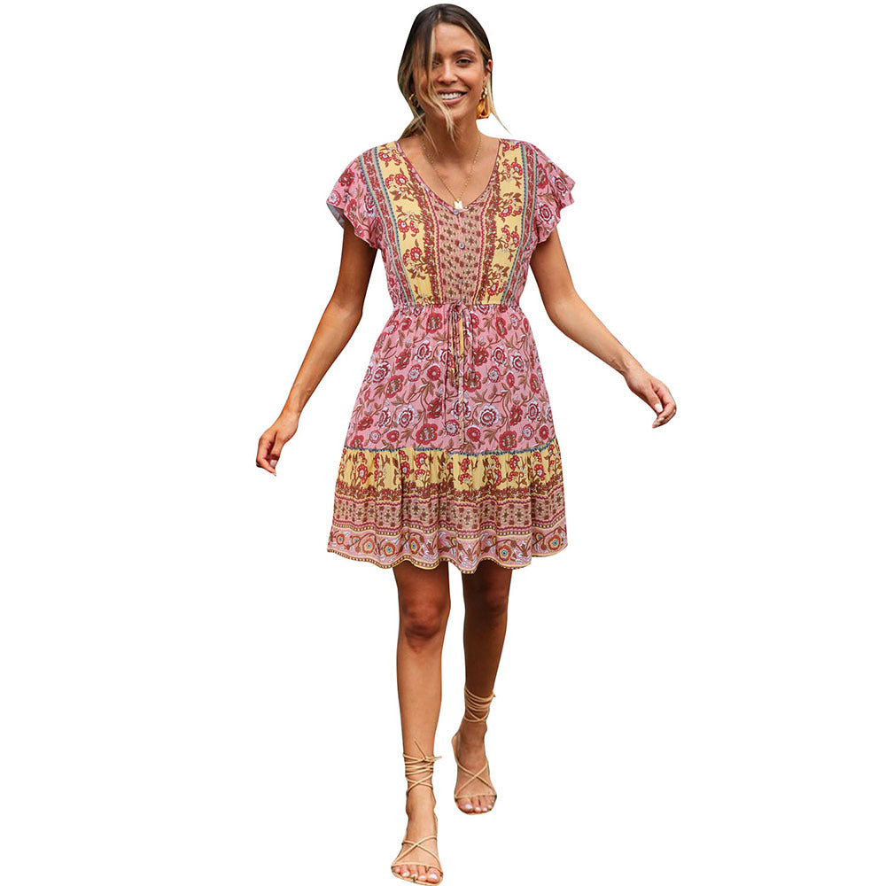 Woman wearing a colorful patterned dress on a white background