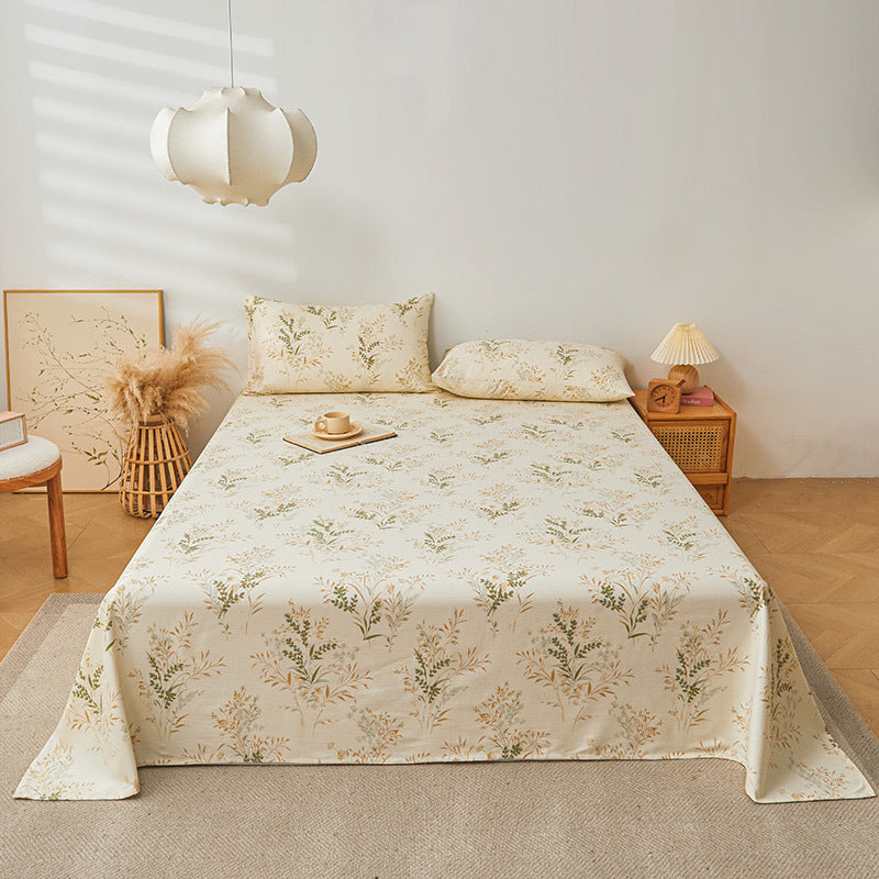 Bedroom with floral-patterned bedspread, pillows, and decor items.
