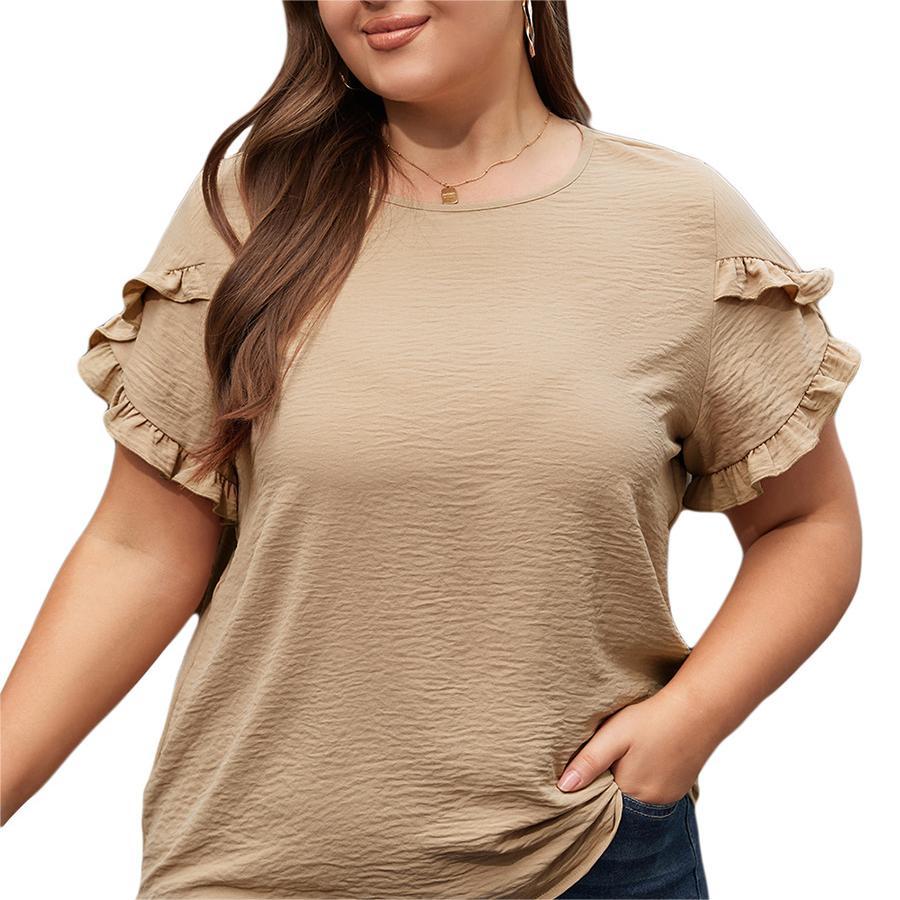 Woman wearing a beige ruffled sleeve top on a white background