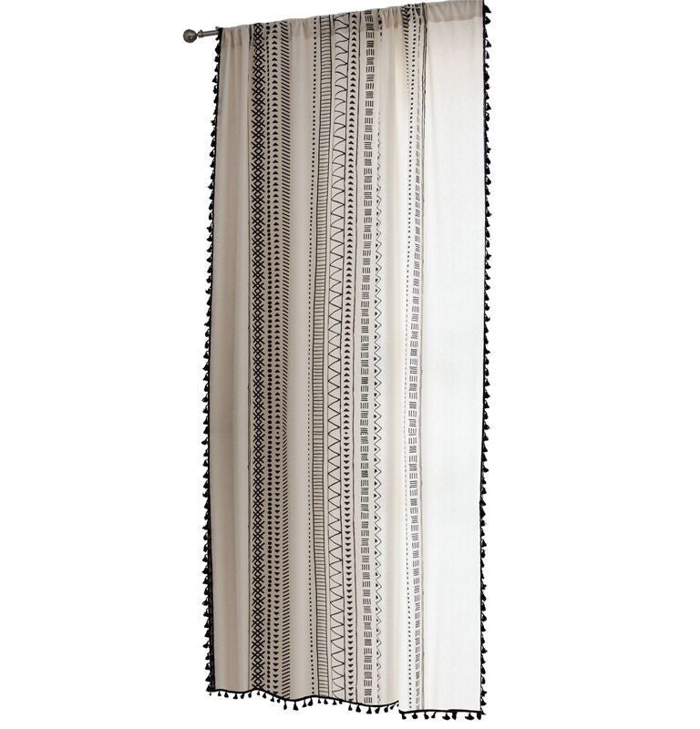 Curtain with geometric pattern and tassels on a white background