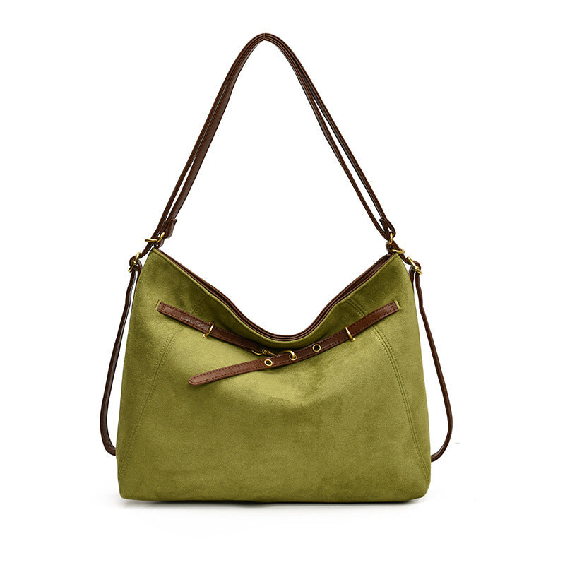 Green handbag with brown straps on a white background