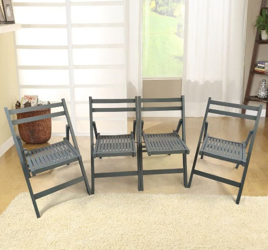 Set of four gray folding chairs in a room with large windows.