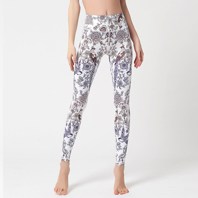Leggings with a floral pattern worn by a person on a white background