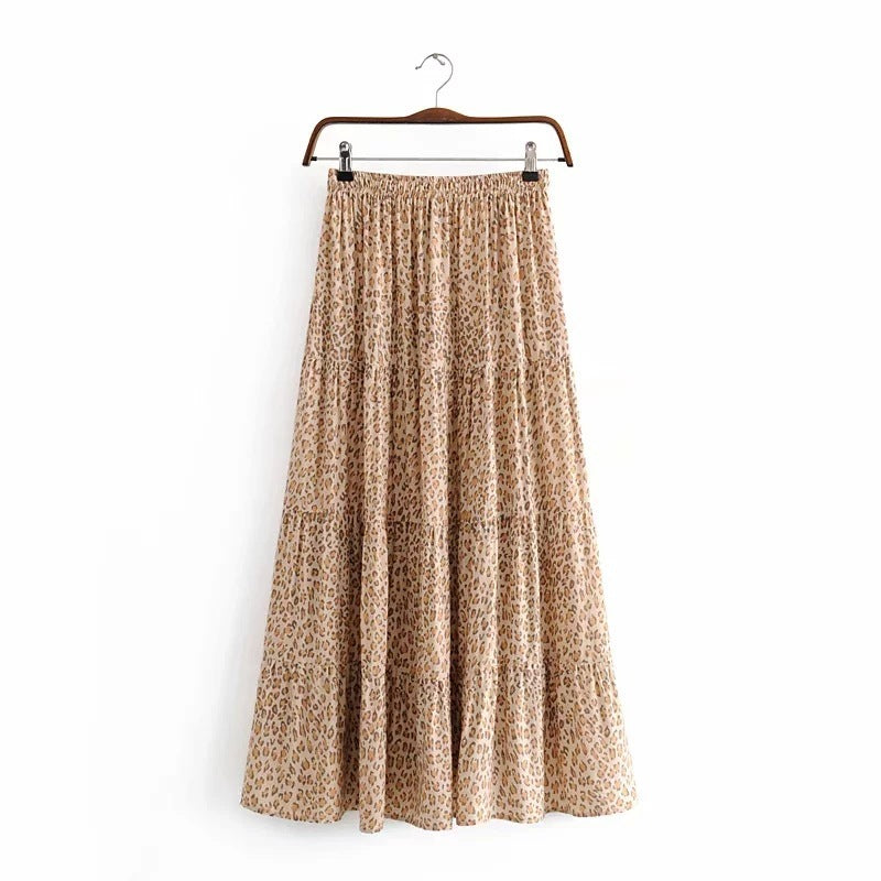 Leopard print skirt on a hanger against a white background