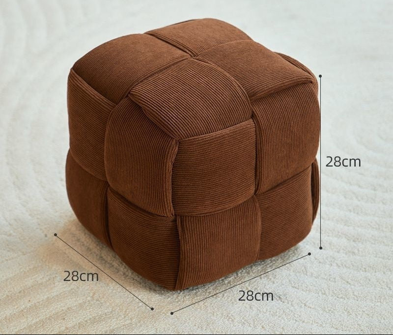 Brown cube-shaped ottoman with dimensions on a light background