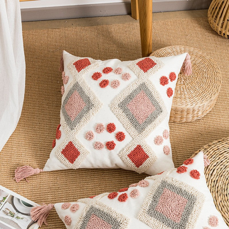 Decorative pillow with geometric pattern on a woven chair