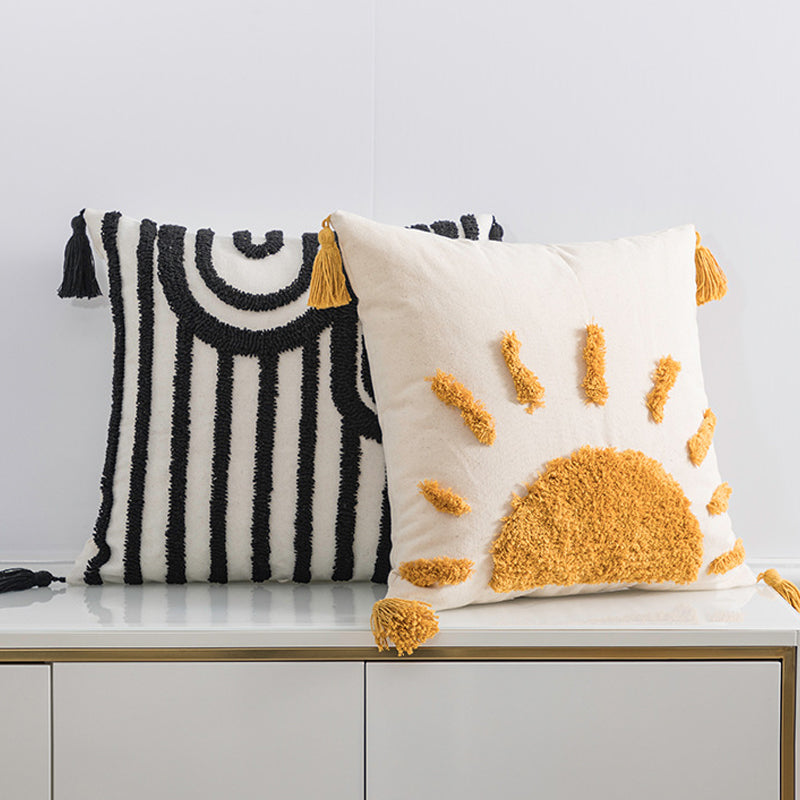 Two decorative pillows with geometric patterns on a white surface.