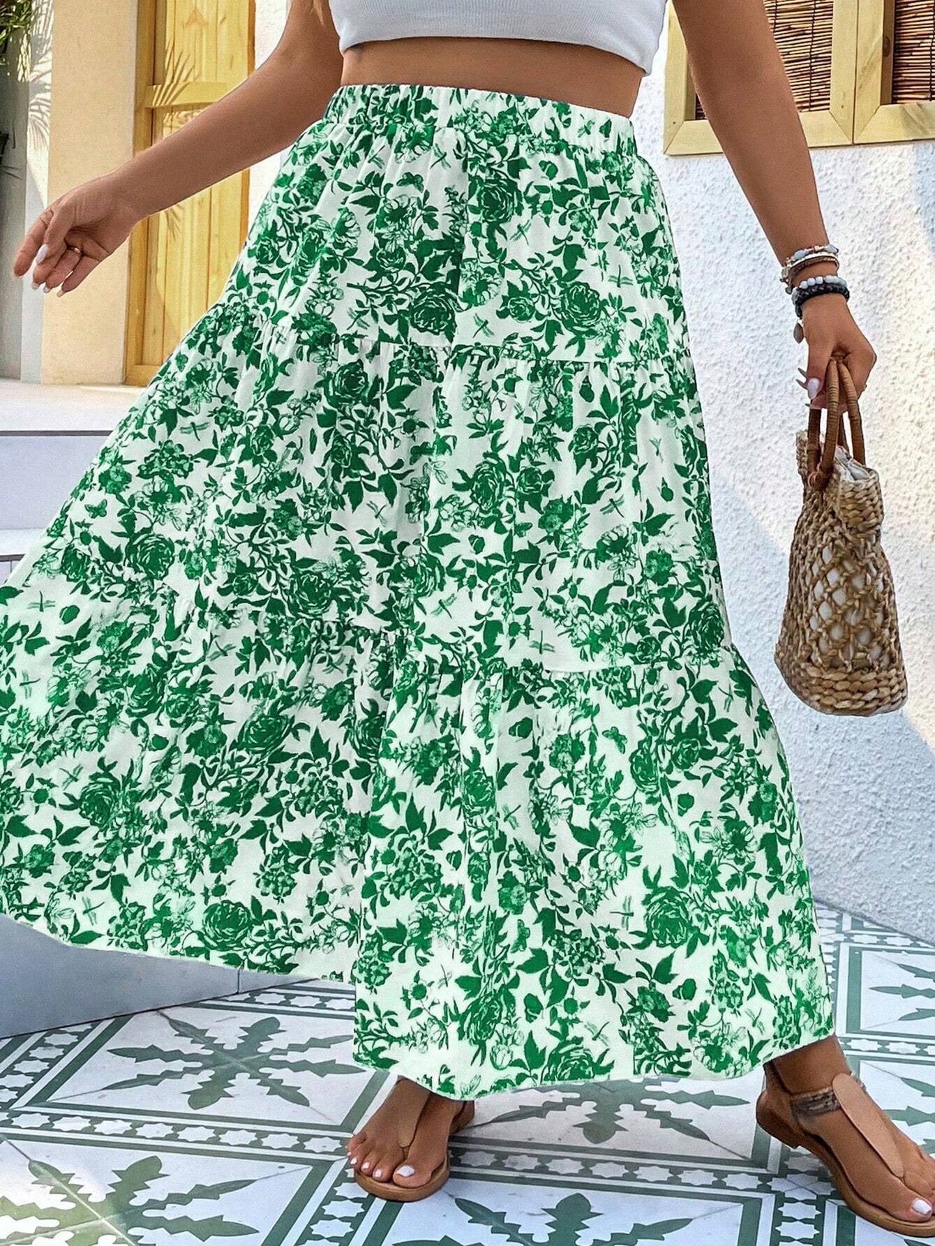 Person wearing a green floral skirt with a white background