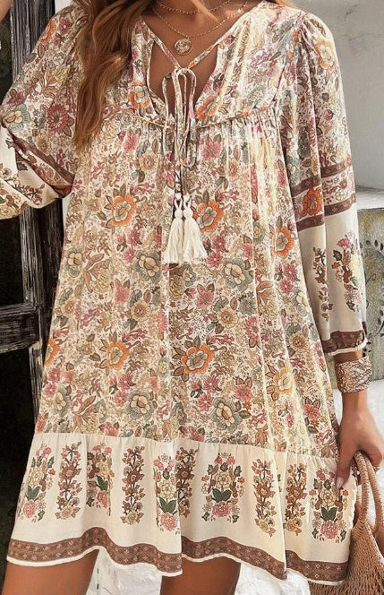 Woman wearing a floral dress with long sleeves in an outdoor setting