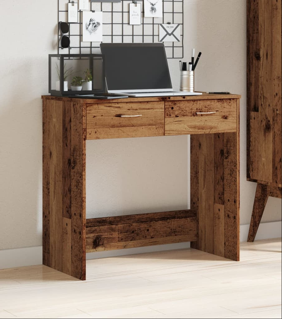 Wooden desk with a laptop and office items in a home office setting.