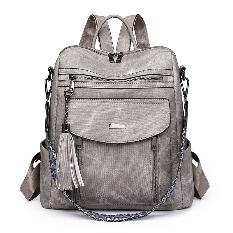 Gray backpack with tassel on a white background