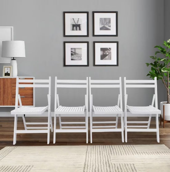 Set of white chairs against a gray wall with framed pictures