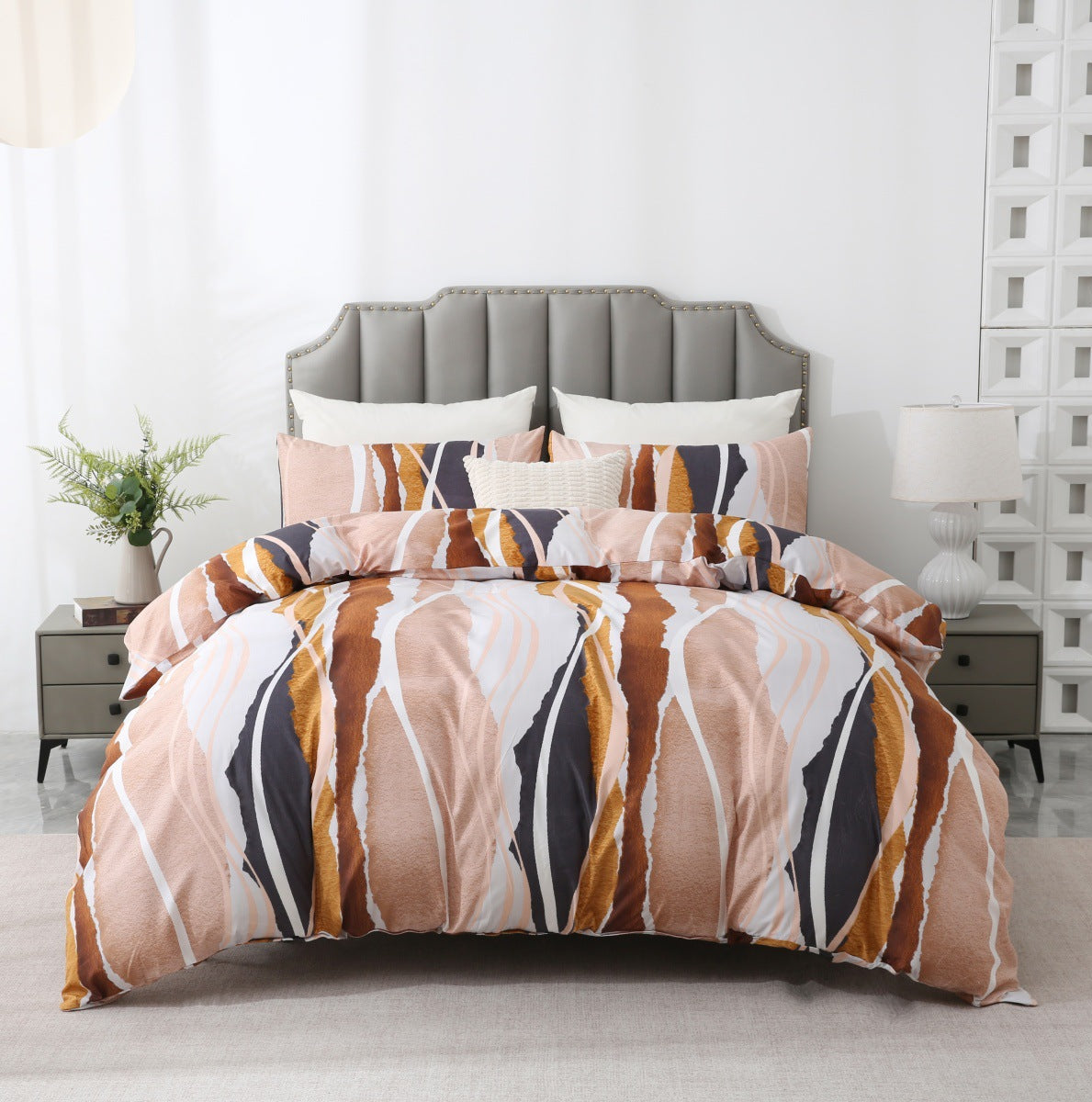 Bed with patterned bedding in a bedroom setting